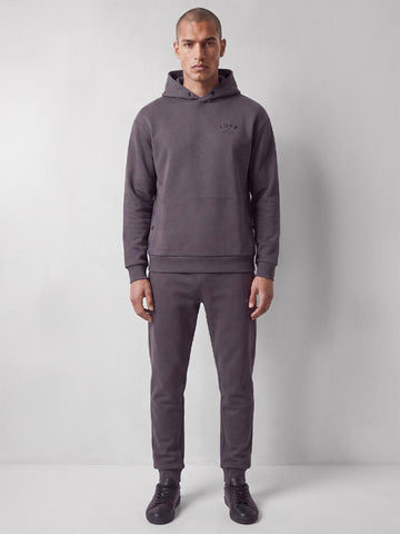 Man wearing charcoal LUKE 1977 Alton lux touch hoodie and joggers tracksuit, front view