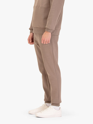 Men's brown joggers with drawstring waistband, worn by a model, worn by a model, side view