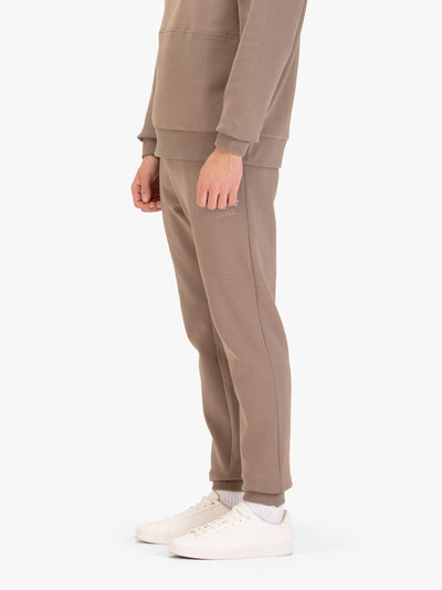 Men's brown joggers with drawstring waistband, worn by a model, worn by a model, side view