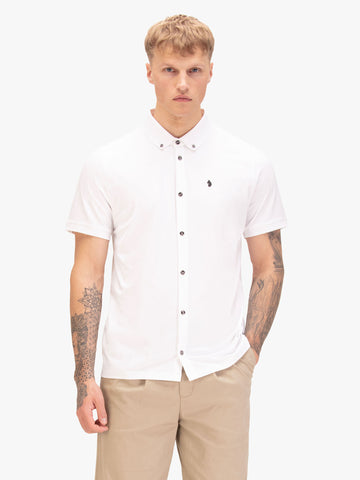 Men's white polo shirt with polo collar, worn by a model, front view