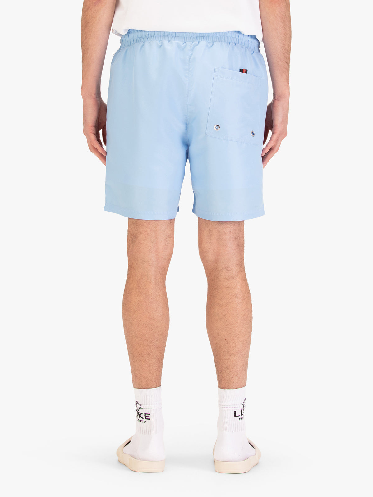 Men's blue-1 swim shorts with drawstring waistband, worn by a model, back view