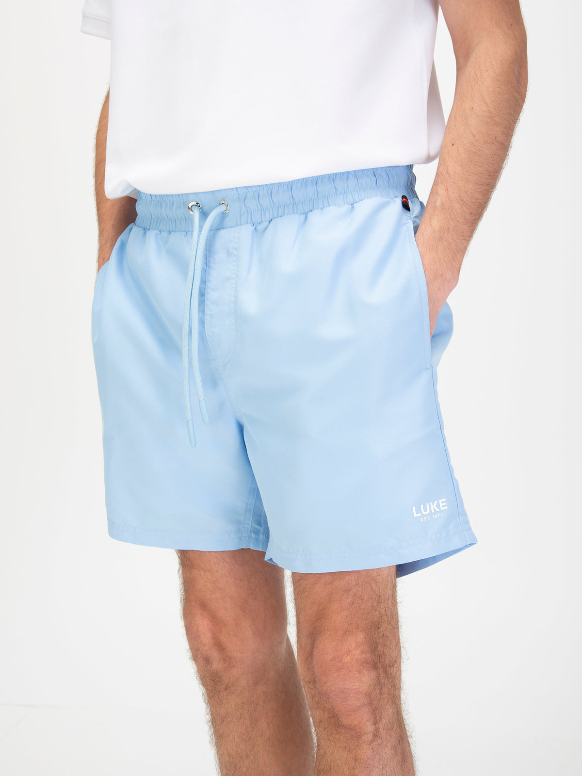 Men's blue-1 swim shorts with drawstring waistband, worn by a model, detail view