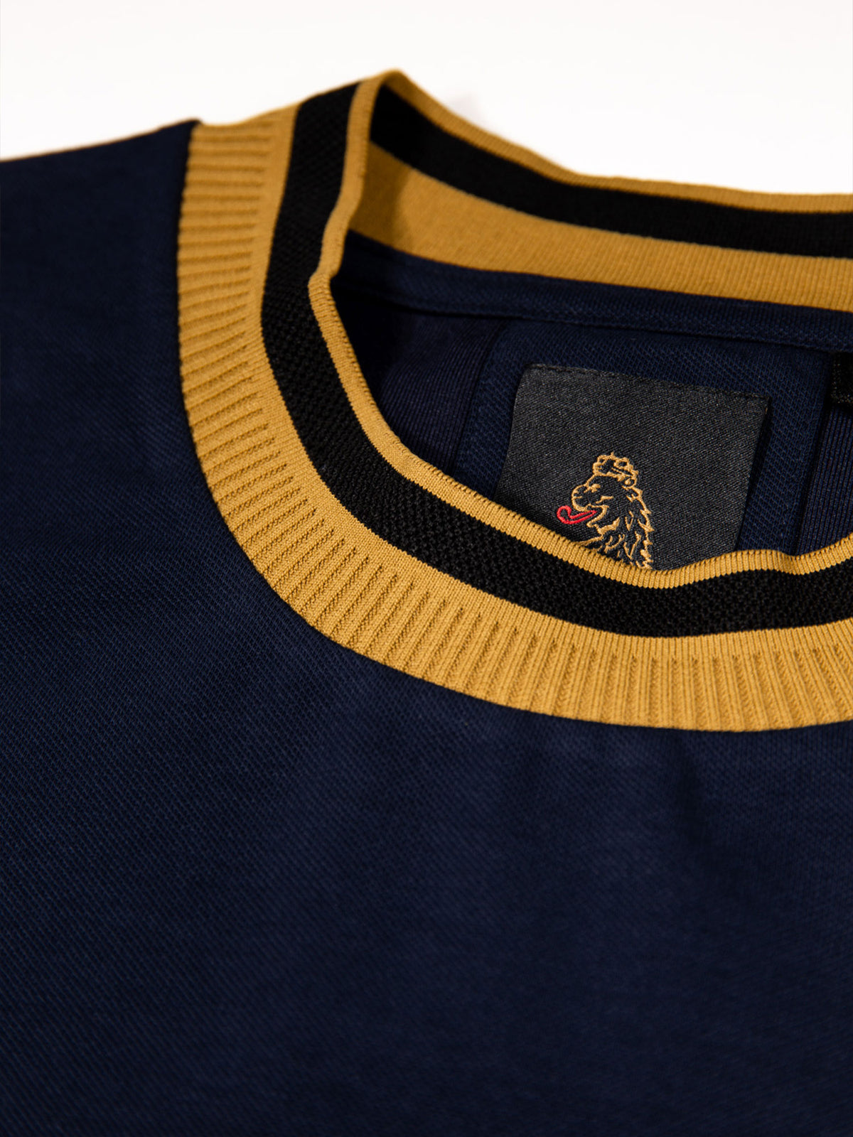 Men's navy t-shirt with crew neck and short sleeves worn by a model - side view.