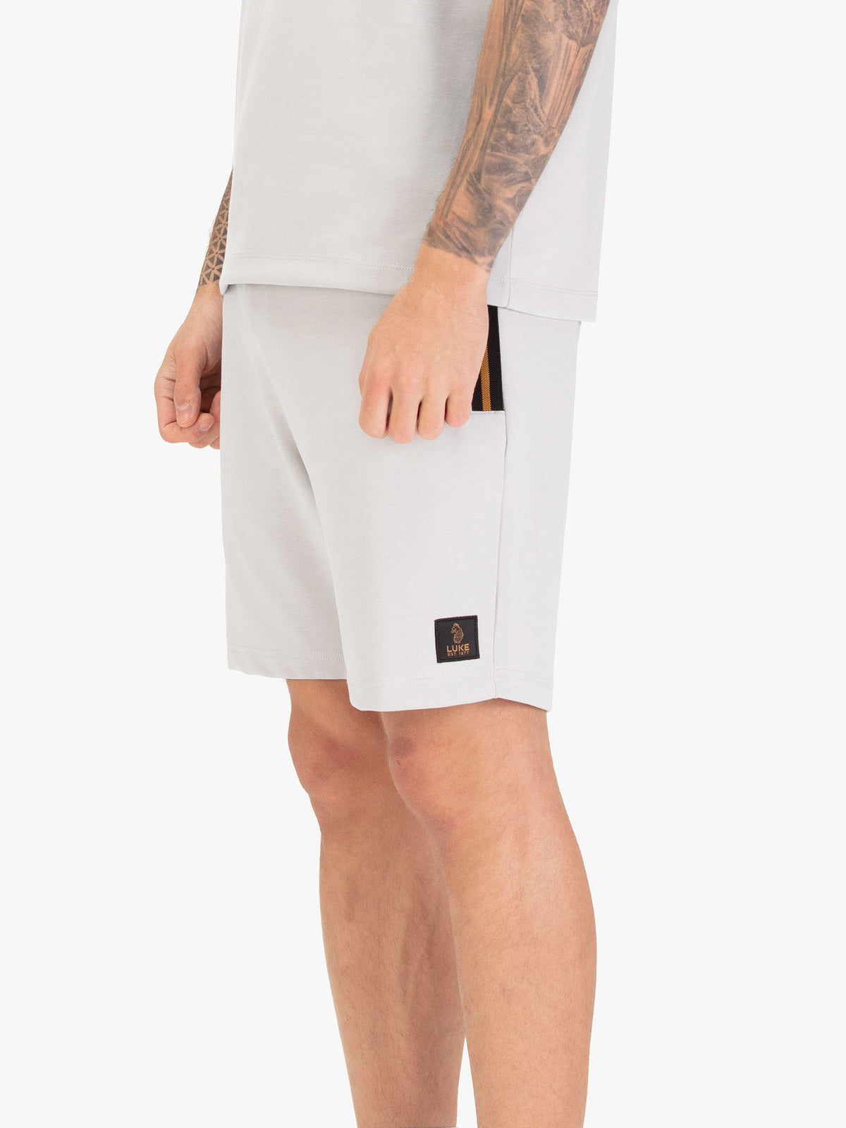Men's grey shorts with drawstring waistband, worn by a model, worn by a model, side view