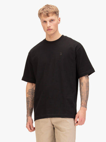 Men's relaxed-fit black t-shirt with crew neck and short sleeves, worn by a model, front view