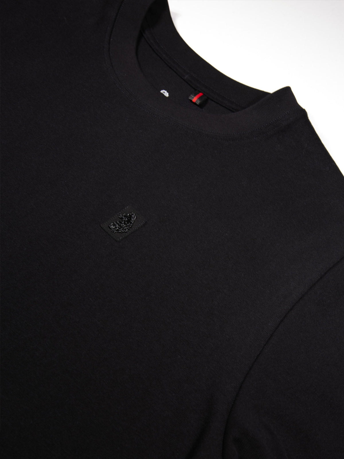Close-up of rib crew neck and LUKE label on black LUKE 1977 Clarke t-shirt