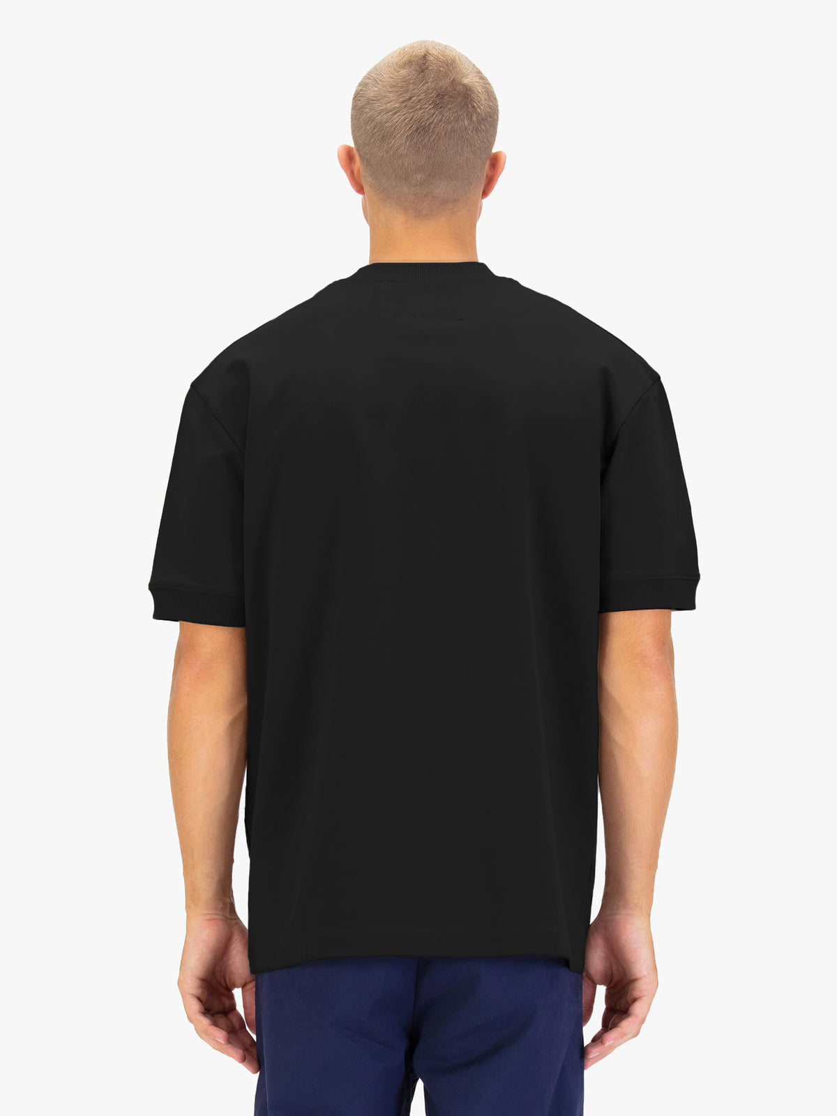 Men's black t-shirt with crew neck and short sleeves worn by a model - back view.