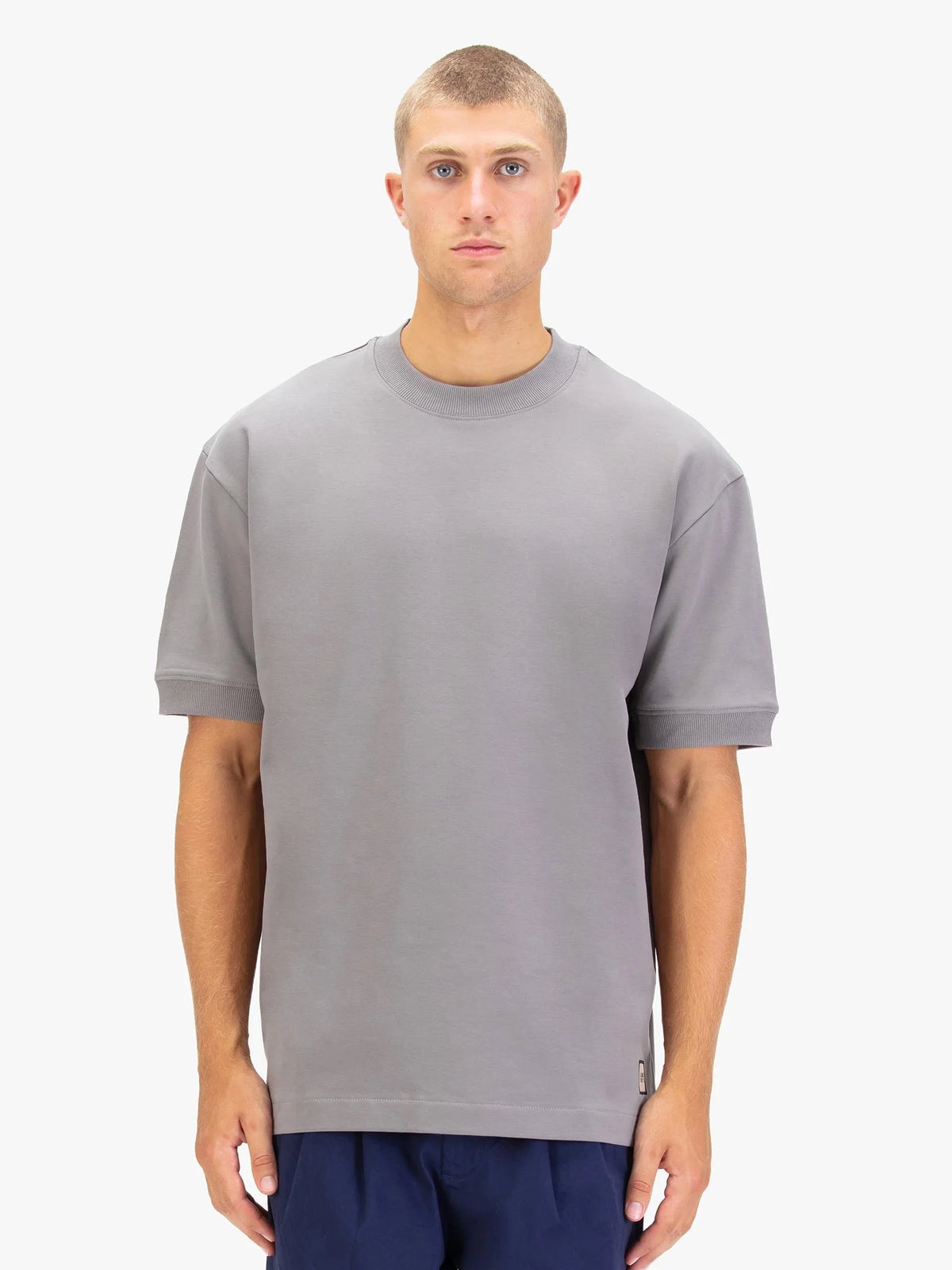 Men's grey t-shirt with crew neck and short sleeves worn by a model - front view.