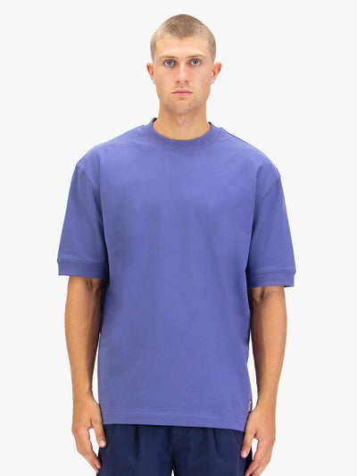 Men's purple t-shirt with crew neck and short sleeves worn by a model - front view.