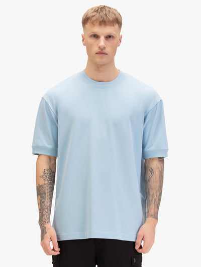 Men's relaxed-fit blue t-shirt with crew neck and short sleeves, worn by a model, front view
