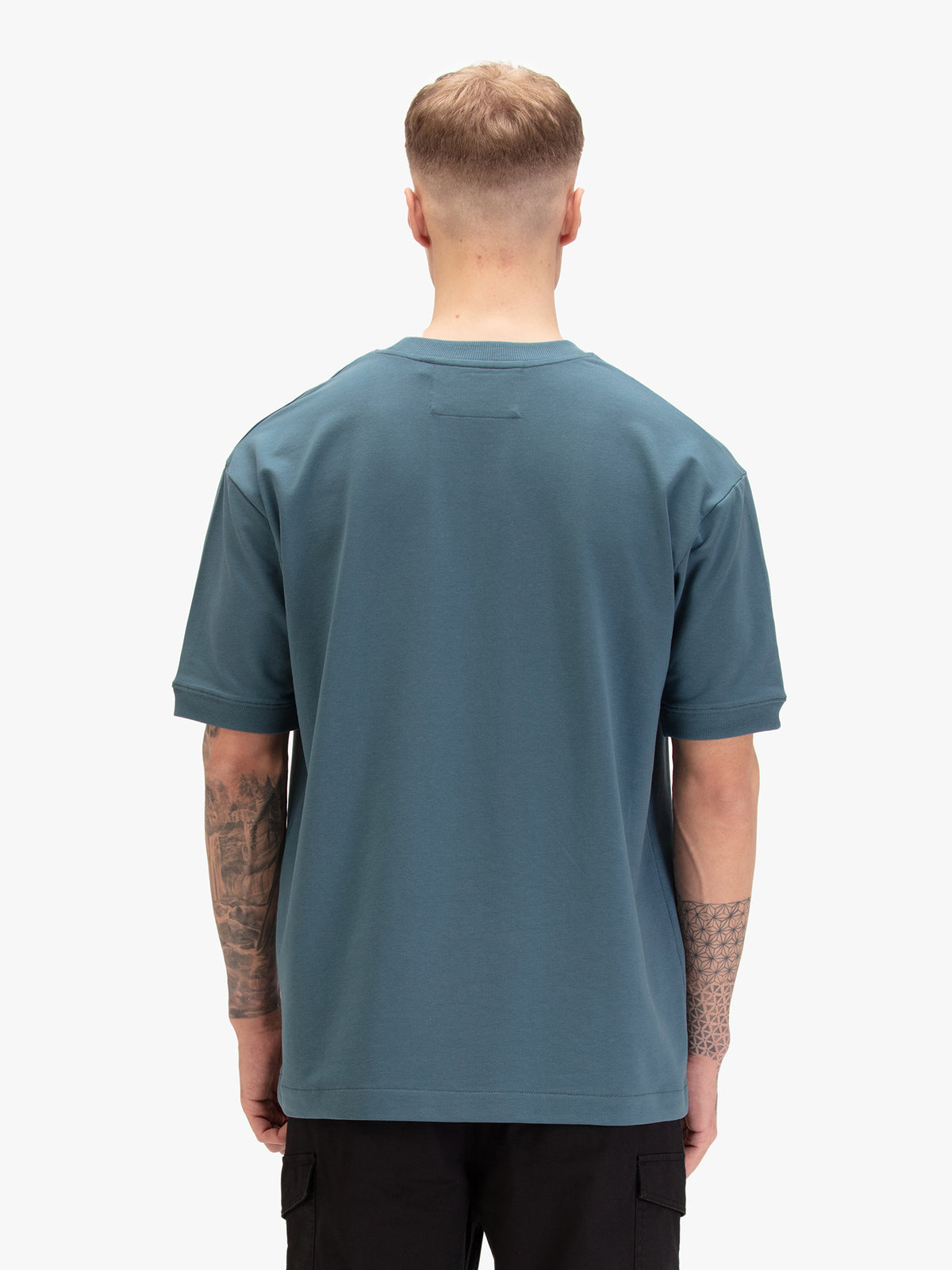 Men's relaxed-fit blue t-shirt with crew neck and short sleeves, worn by a model, back view