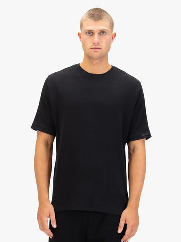 Men's black t-shirt with crew neck and short sleeves worn by a model - front view.