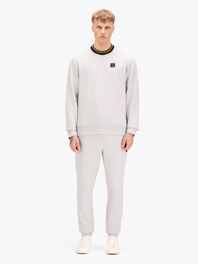 Men's grey tracksuit with sweatshirt and matching joggers, worn by model.