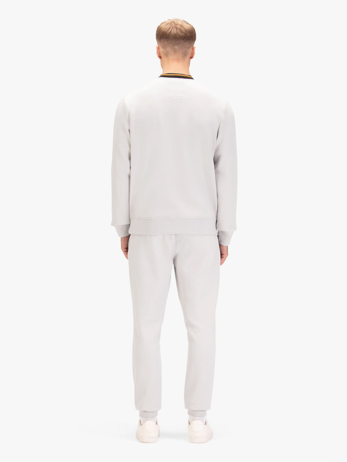 Men's grey tracksuit with sweatshirt and matching joggers, worn by a model, back view.