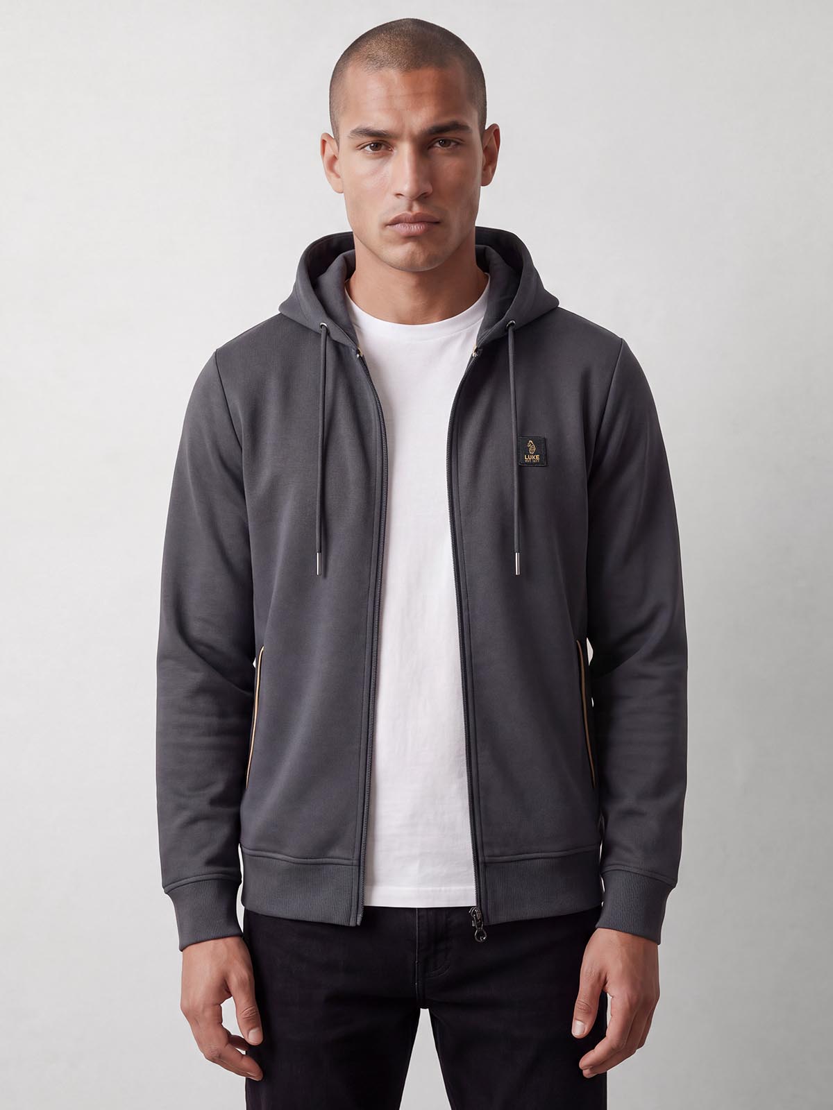 Man wearing open charcoal LUKE 1977 Makati zip through hoodie over white t-shirt, front view