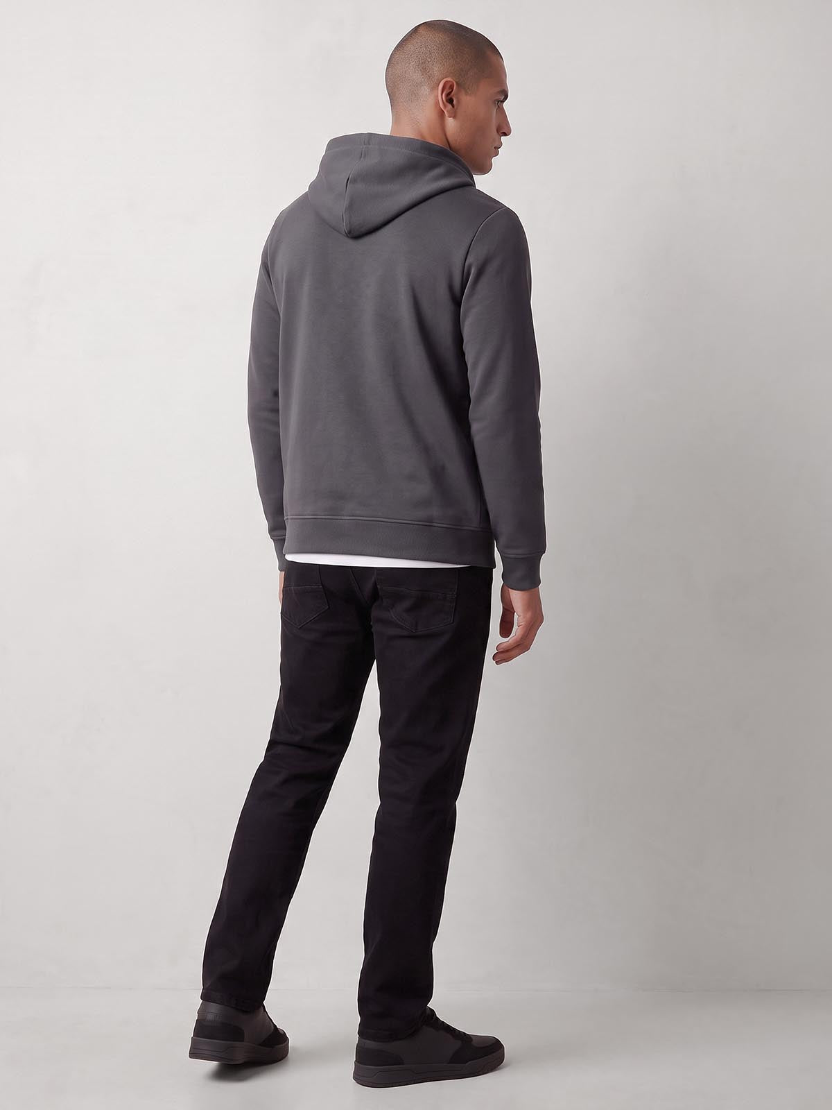 Rear side view of man wearing charcoal LUKE 1977 Makati zip through hoodie with hood