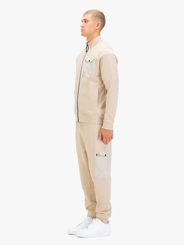 Men's beige tracksuit with zip-through sweatshirt and matching joggers.