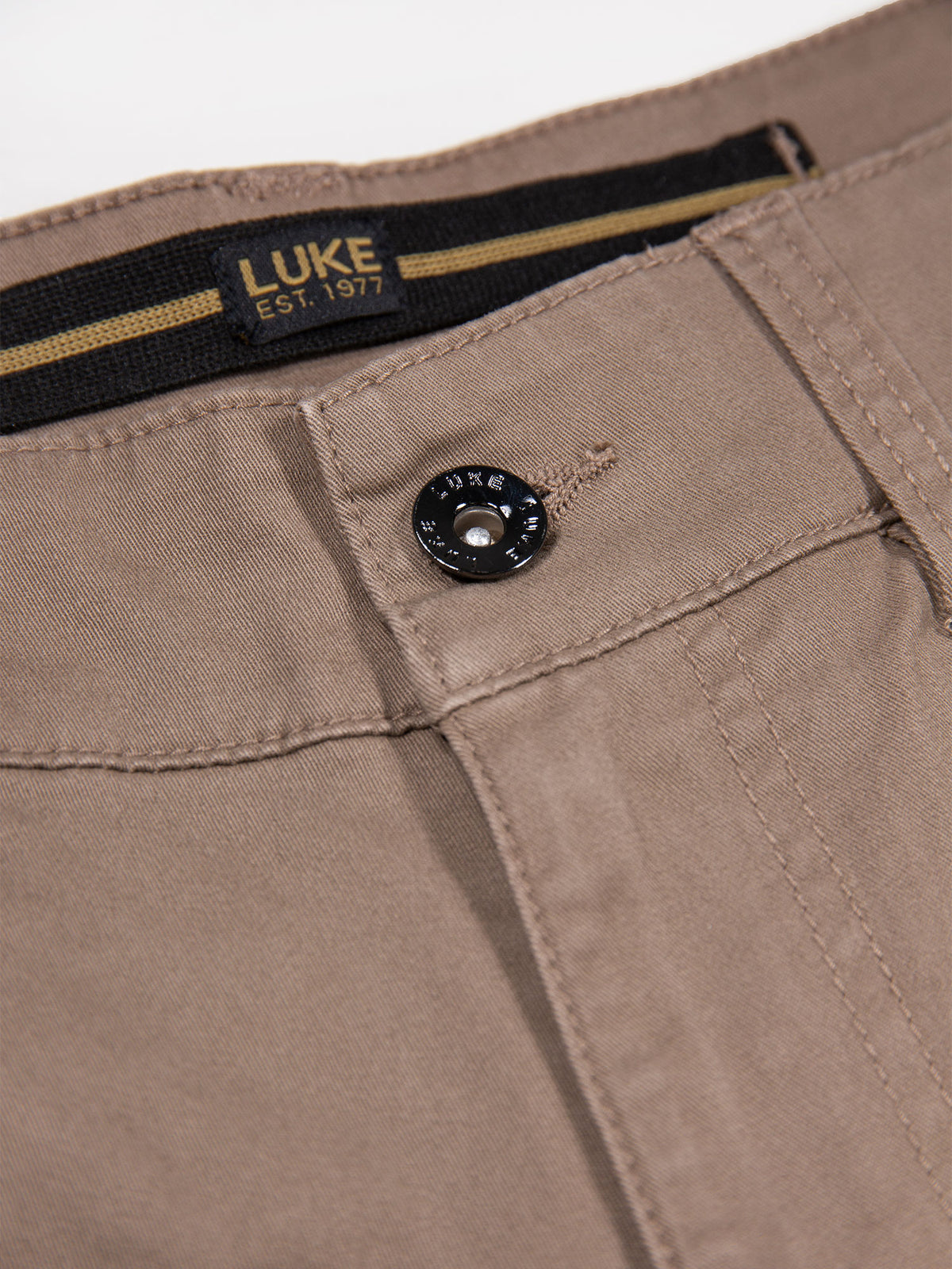 Close-up of LUKE text metallic button and woven waistband label on Hardnut brown Panama cargo trousers