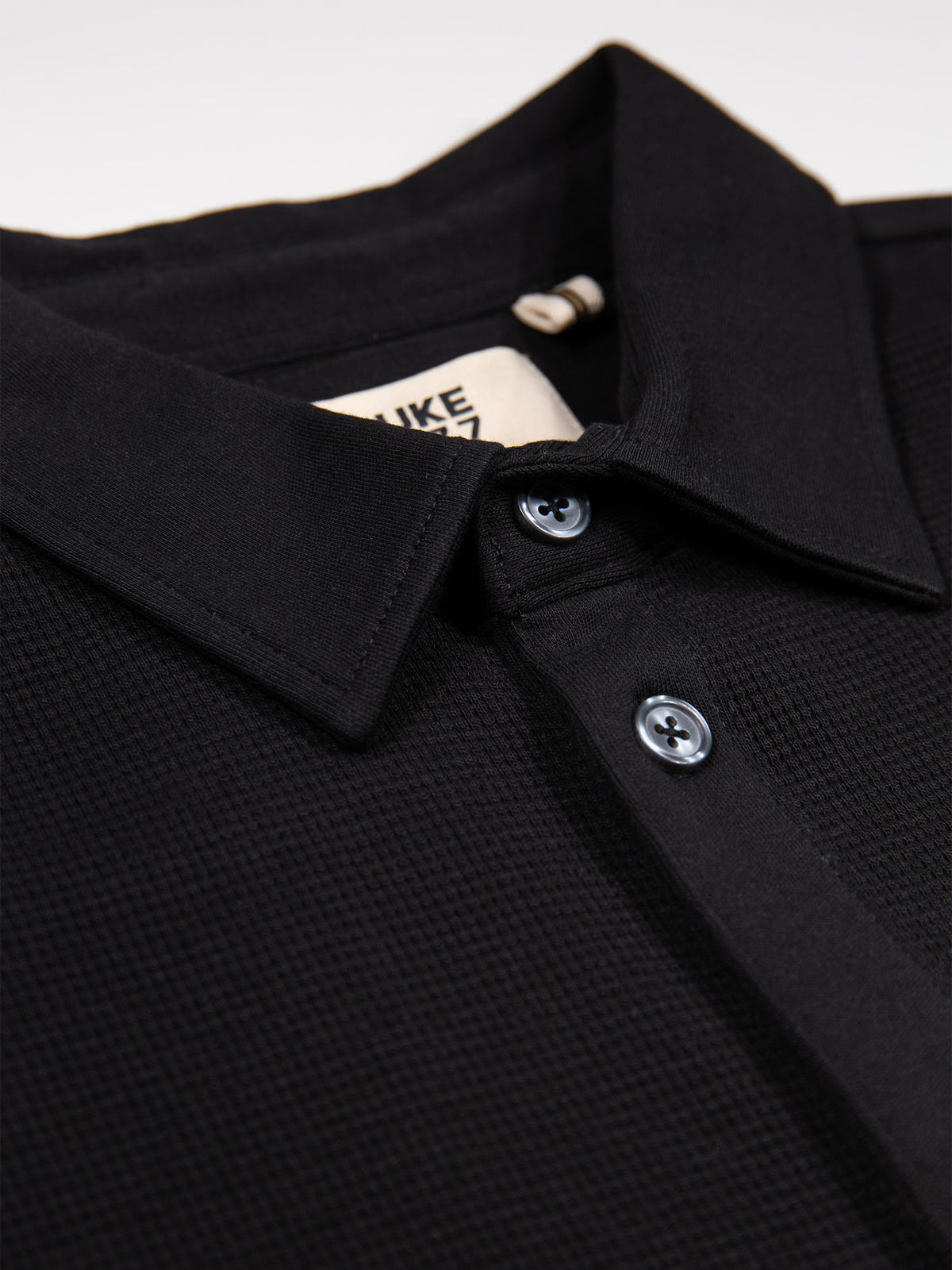 Men's black polo shirt with polo collar.