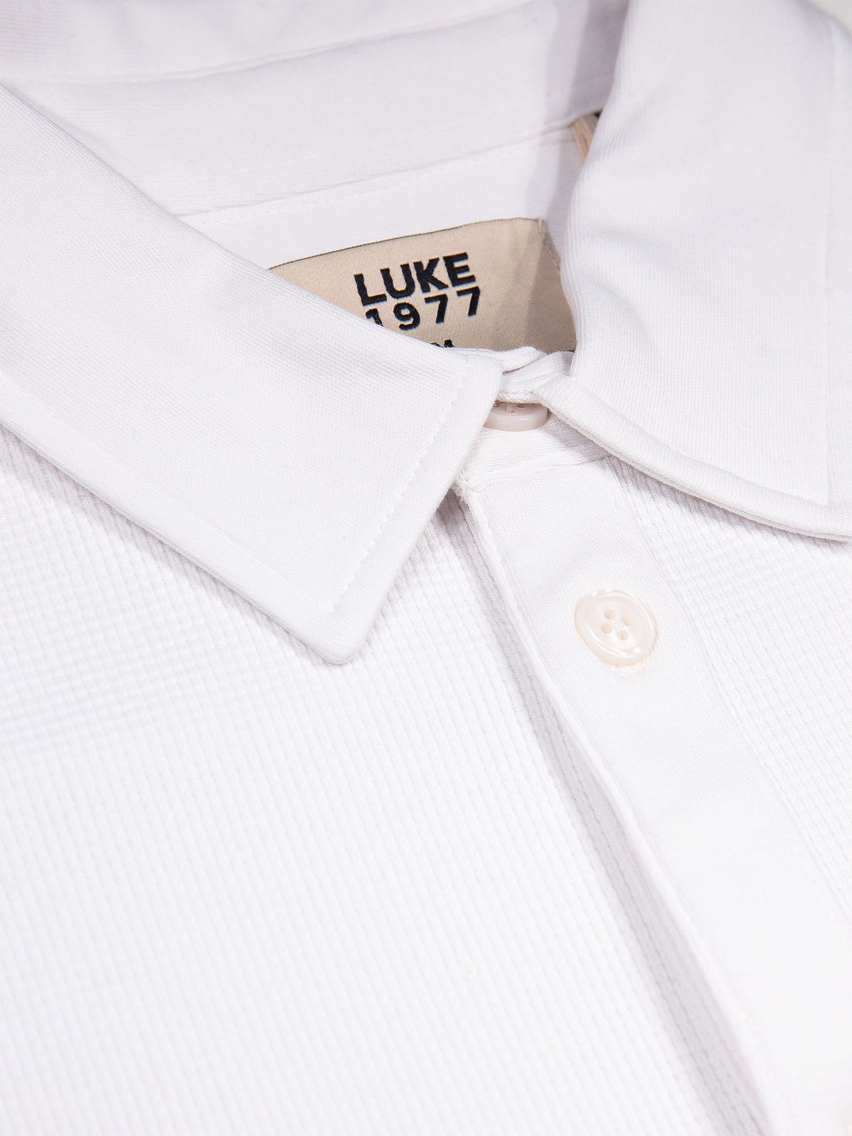 Men's white polo shirt with polo collar.