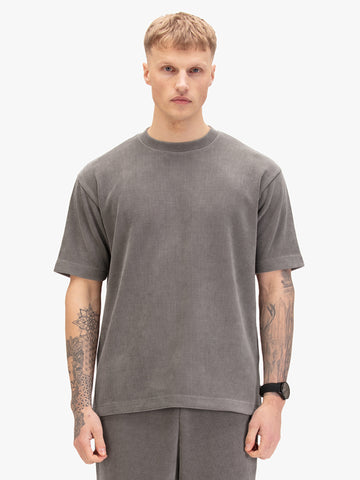 Men's relaxed-fit grey t-shirt with crew neck and short sleeves, worn by a model, front view