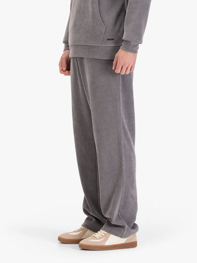 Men's straight-leg grey joggers, worn by a model, side view