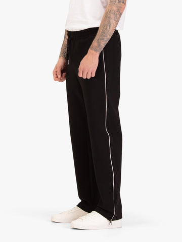 Men's straight-leg black joggers with drawstring waistband, worn by a model, side view