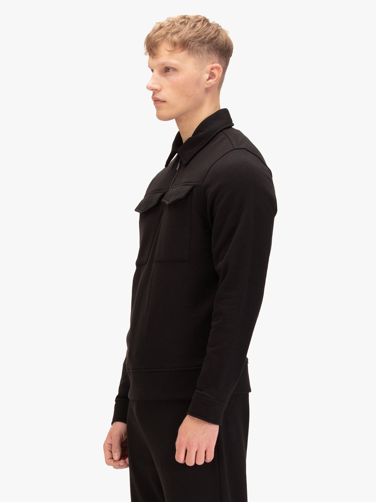 Men's slim-fit black sweatshirt with quarter-zip neck and chest pocket, back view