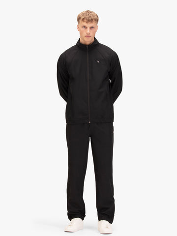 Men's black tracksuit with zip-up sweatshirt and matching joggers, worn by model.