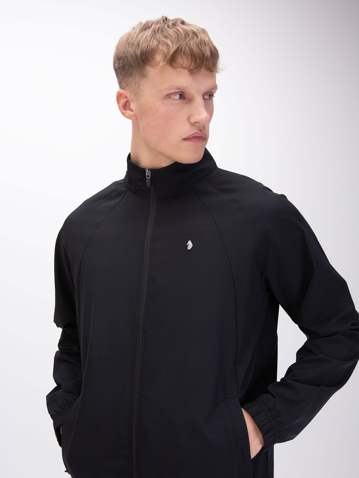 Close front view of model in black LUKE 1977 Moseley zip sweatshirt with metal lion rivet