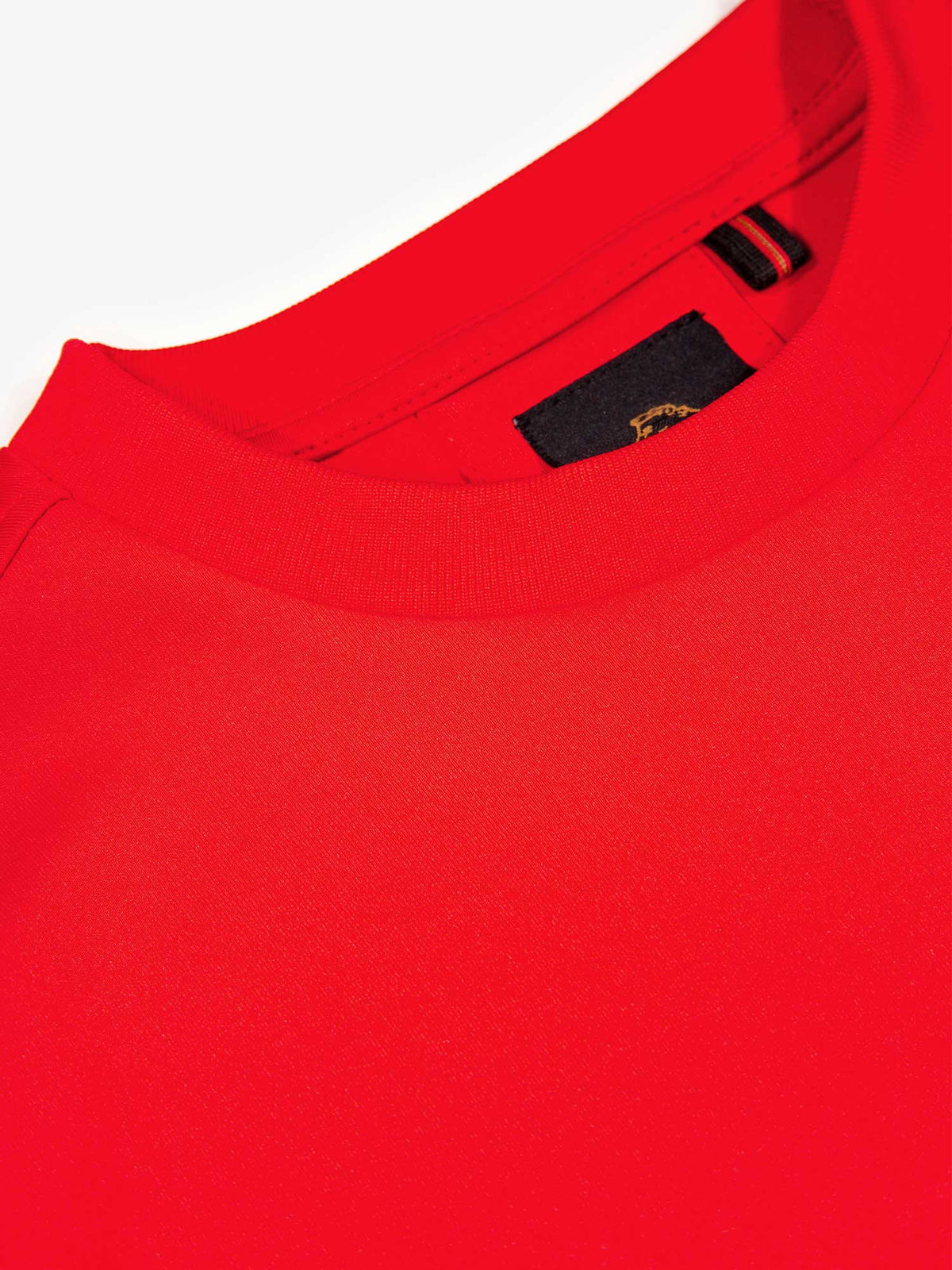 Close-up of soft rib crew neck and LUKE label on red Noel tricot sweatshirt