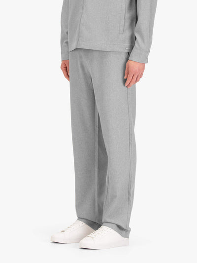 Men's straight-leg grey trousers with elasticated waistband, worn by a model, side view