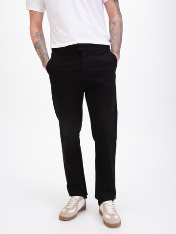 Men's straight-leg black trousers, worn by a model, detail view