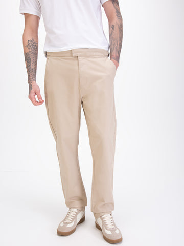 Men's straight-leg beige trousers, worn by a model, detail view