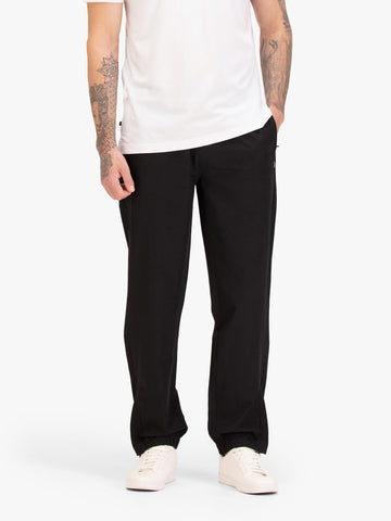 Men's black joggers with elasticated waistband, worn by a model, front view