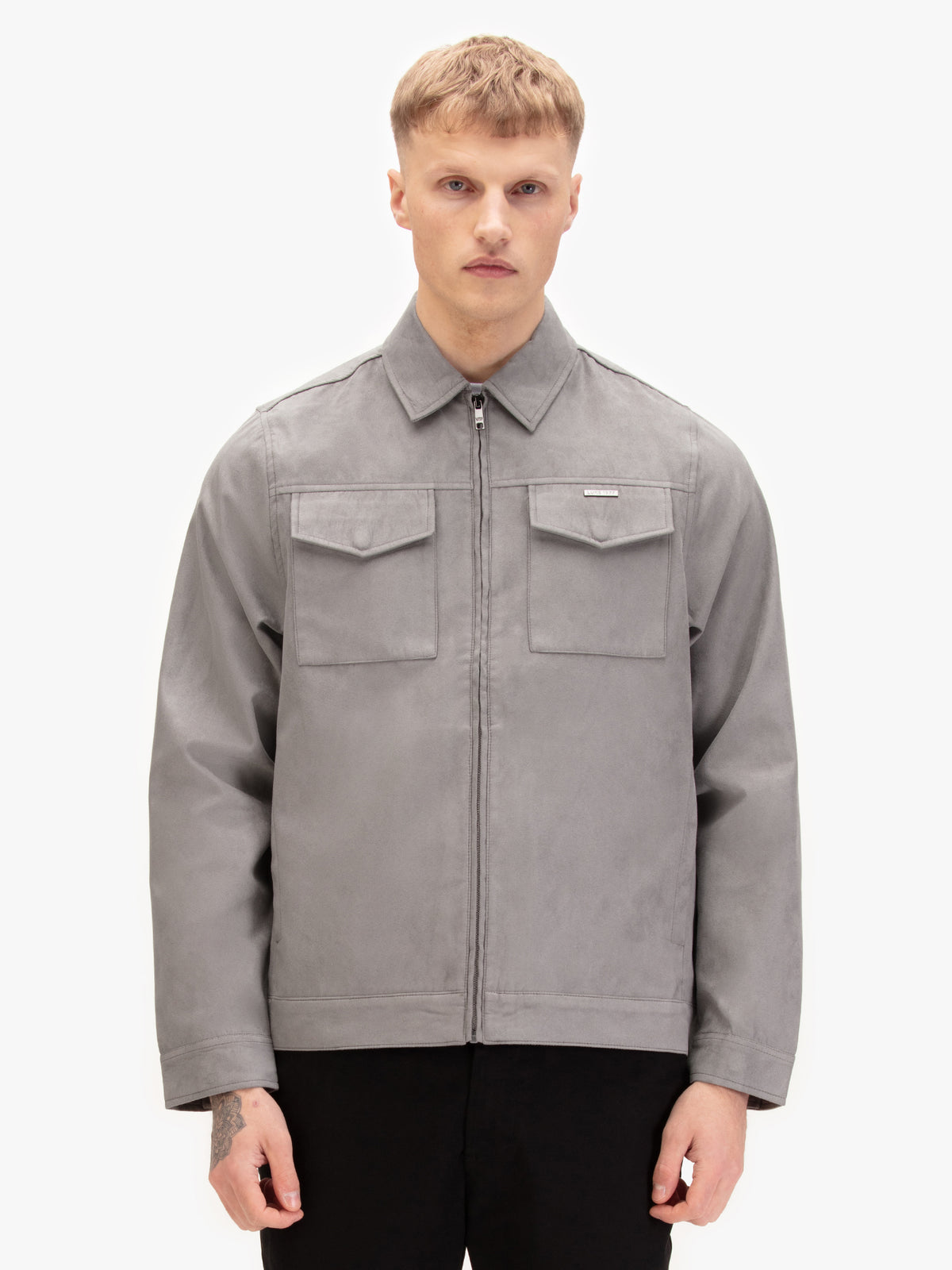 Men's grey jacket with zip-up front and front pocket, worn by a model, side view