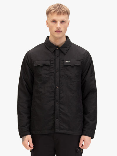 Men's black jacket with button-up front and front pocket, worn by a model, front view