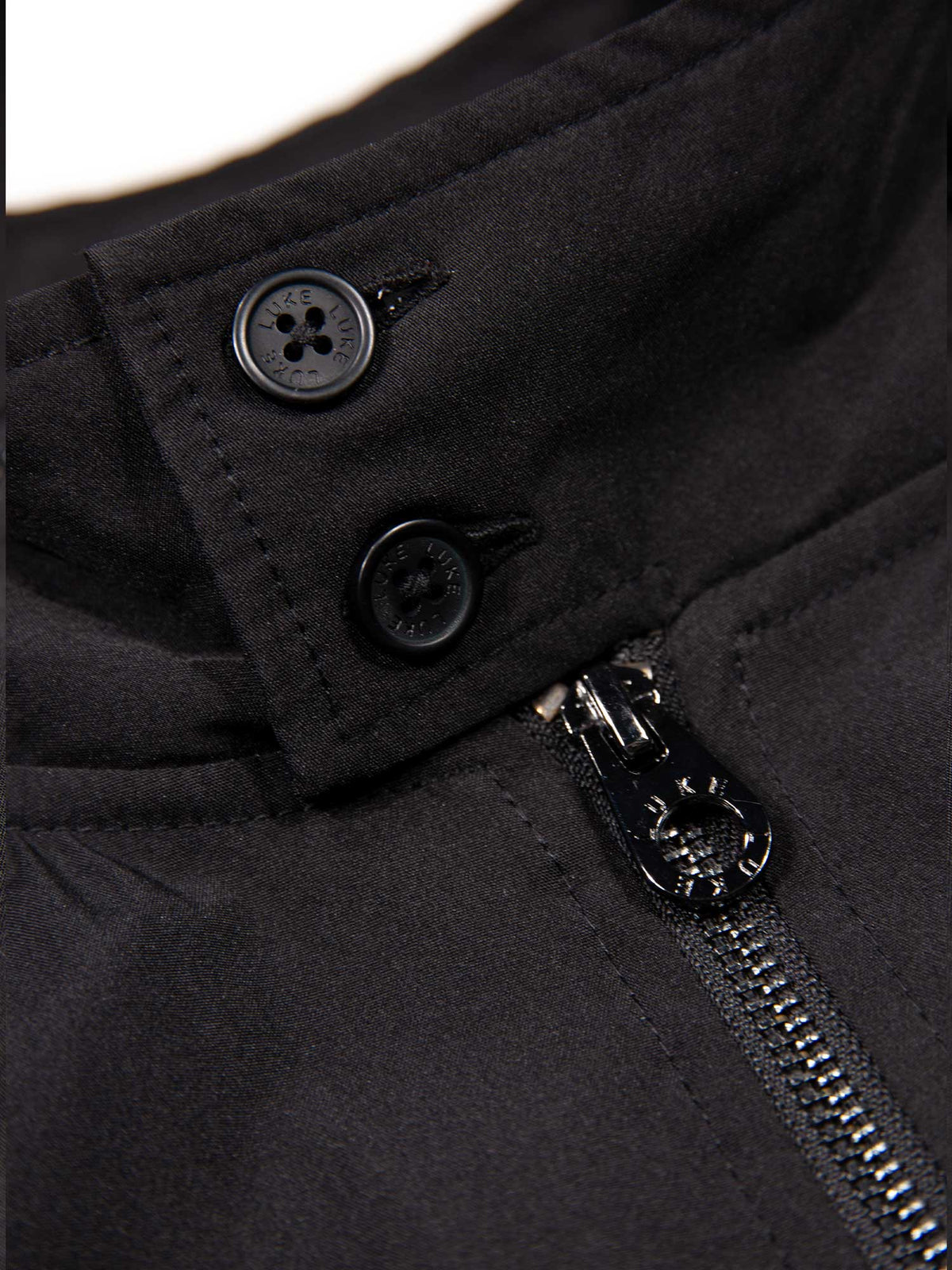 Men's black jacket with zip-up front and front pocket, detail view 2