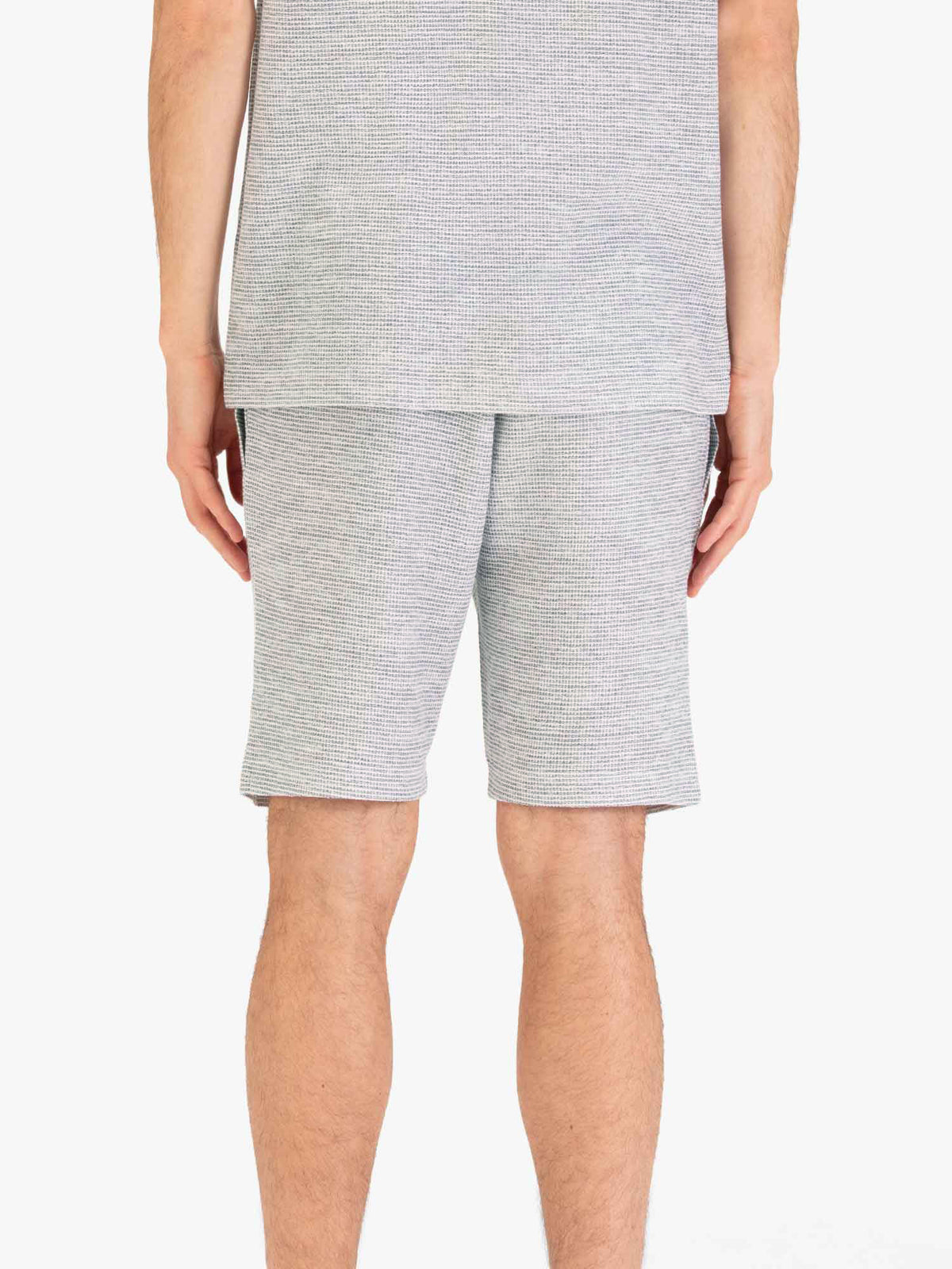 Men's grey shorts with drawstring waistband, worn by a model, back view
