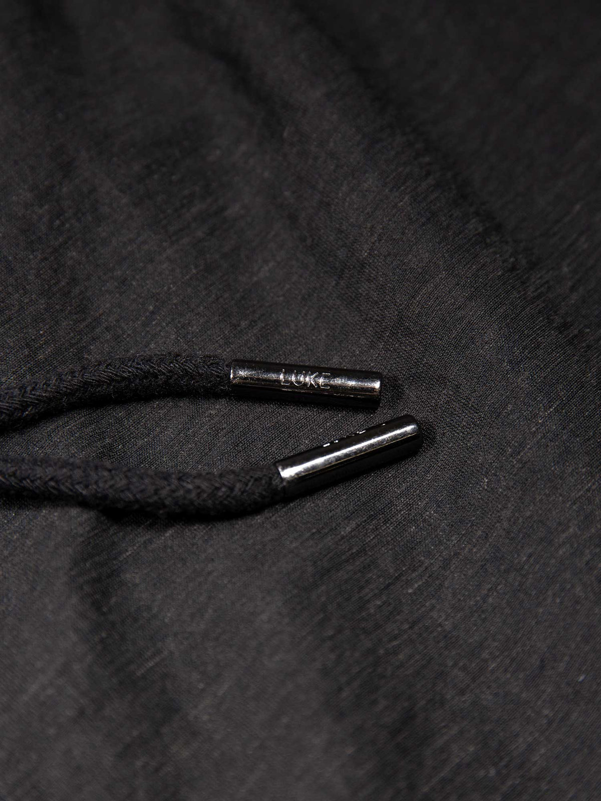 Men's black shorts with drawstring waistband and cargo pockets, detail view 2