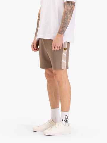 Men's brown shorts with drawstring waistband, worn by a model, side view