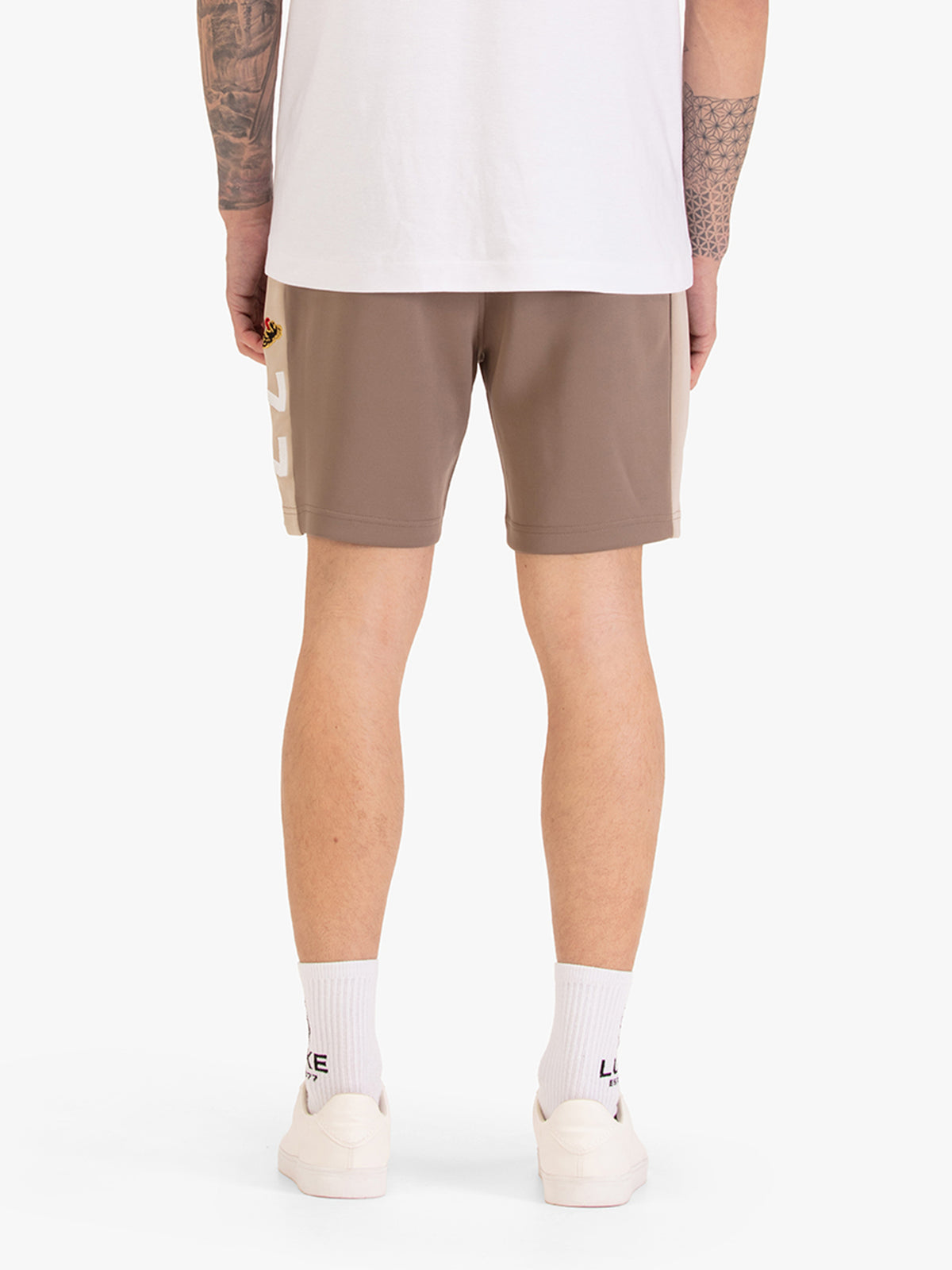 Men's brown shorts with drawstring waistband, worn by a model, back view