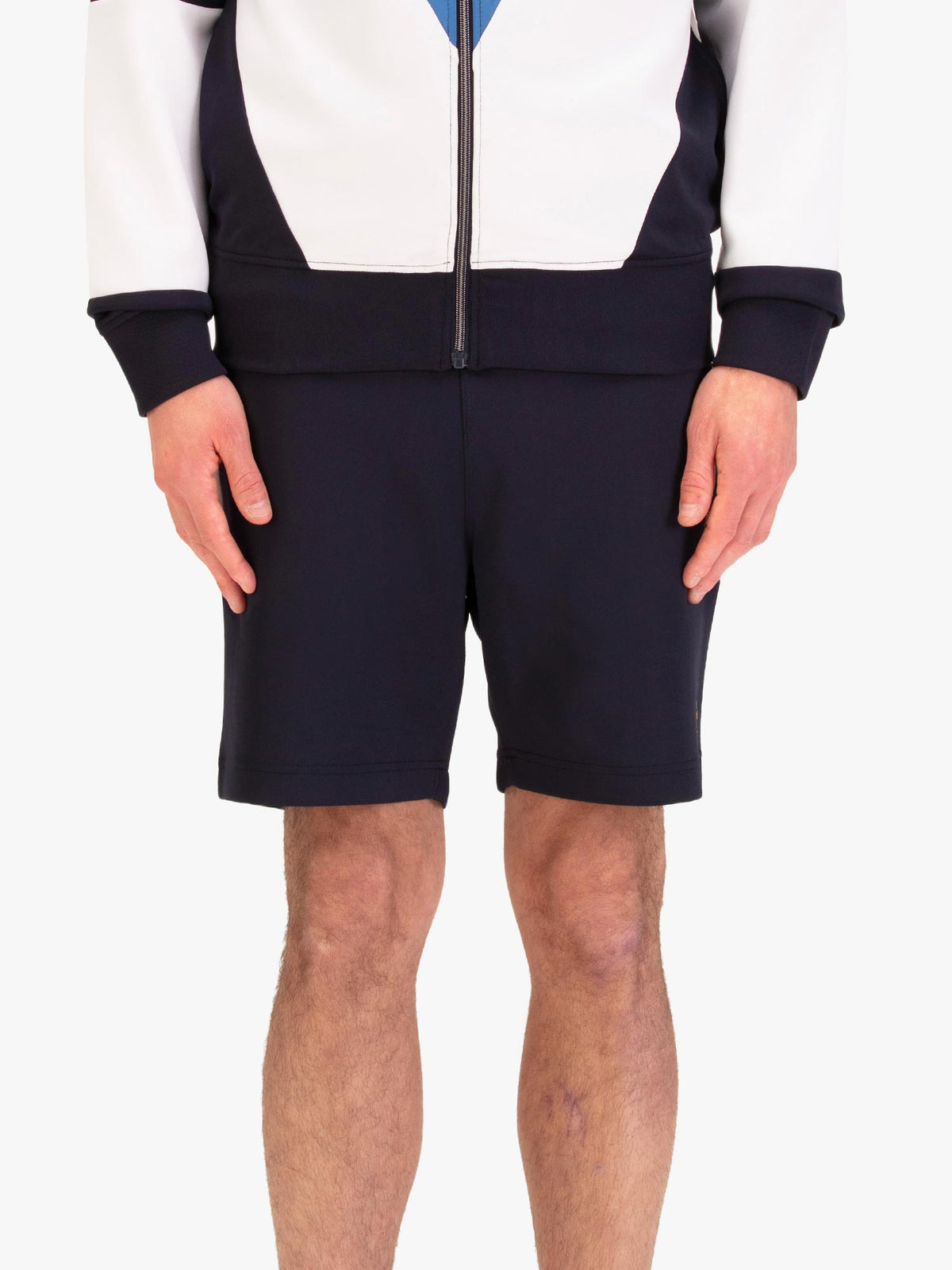 Men's navy shorts with drawstring waistband, worn by a model, front view