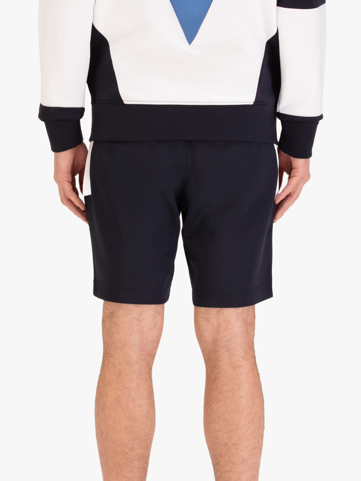 Men's navy shorts with drawstring waistband, worn by a model, back view