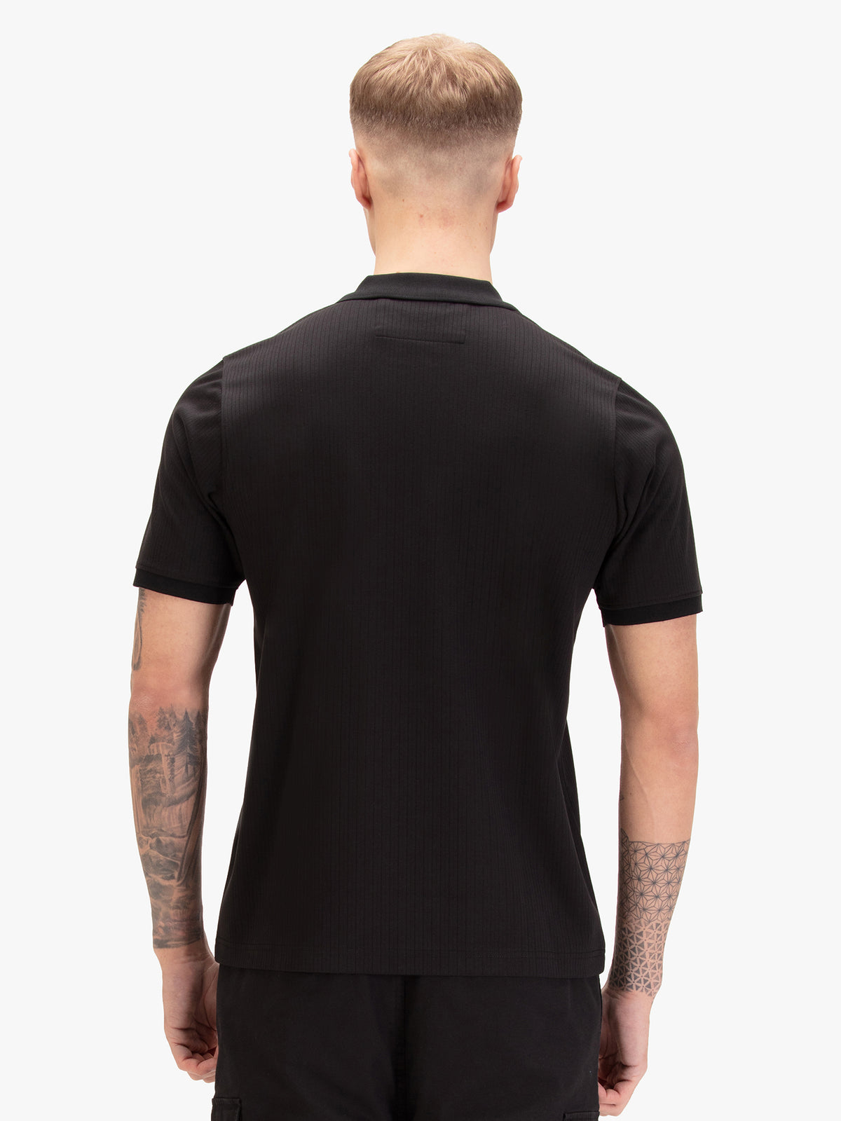 Men's black polo shirt with polo collar, worn by a model, back view