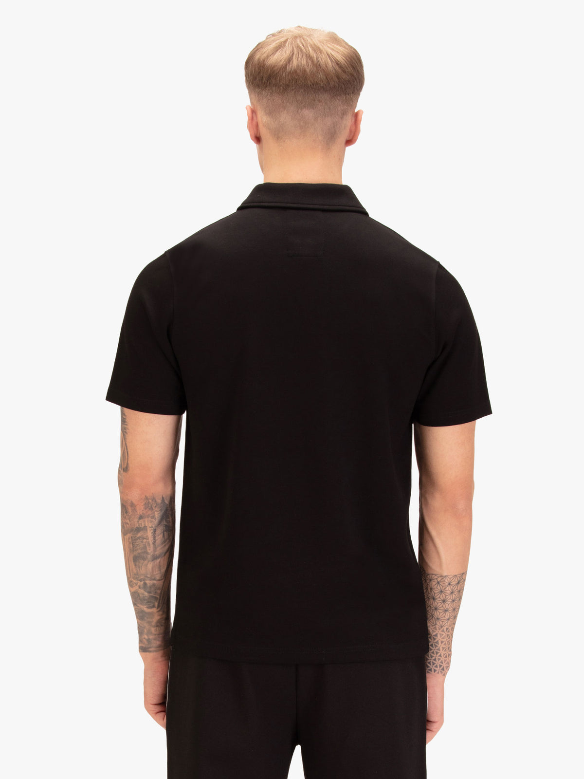 Men's black polo shirt with polo collar, worn by a model, back view