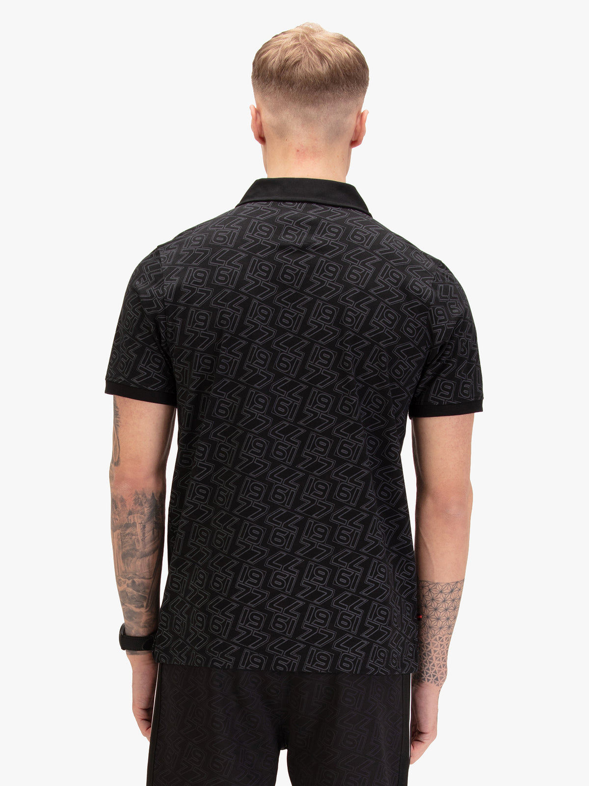 Men's black polo shirt with polo collar, worn by a model, back view