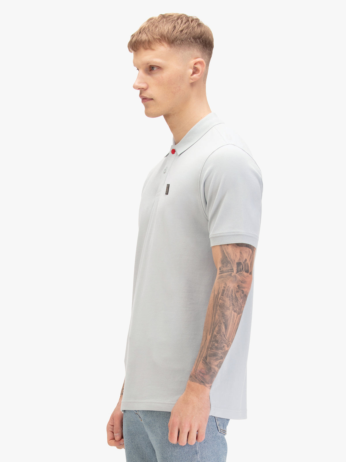 Men's blue-1 polo shirt with polo collar, worn by a model, side view
