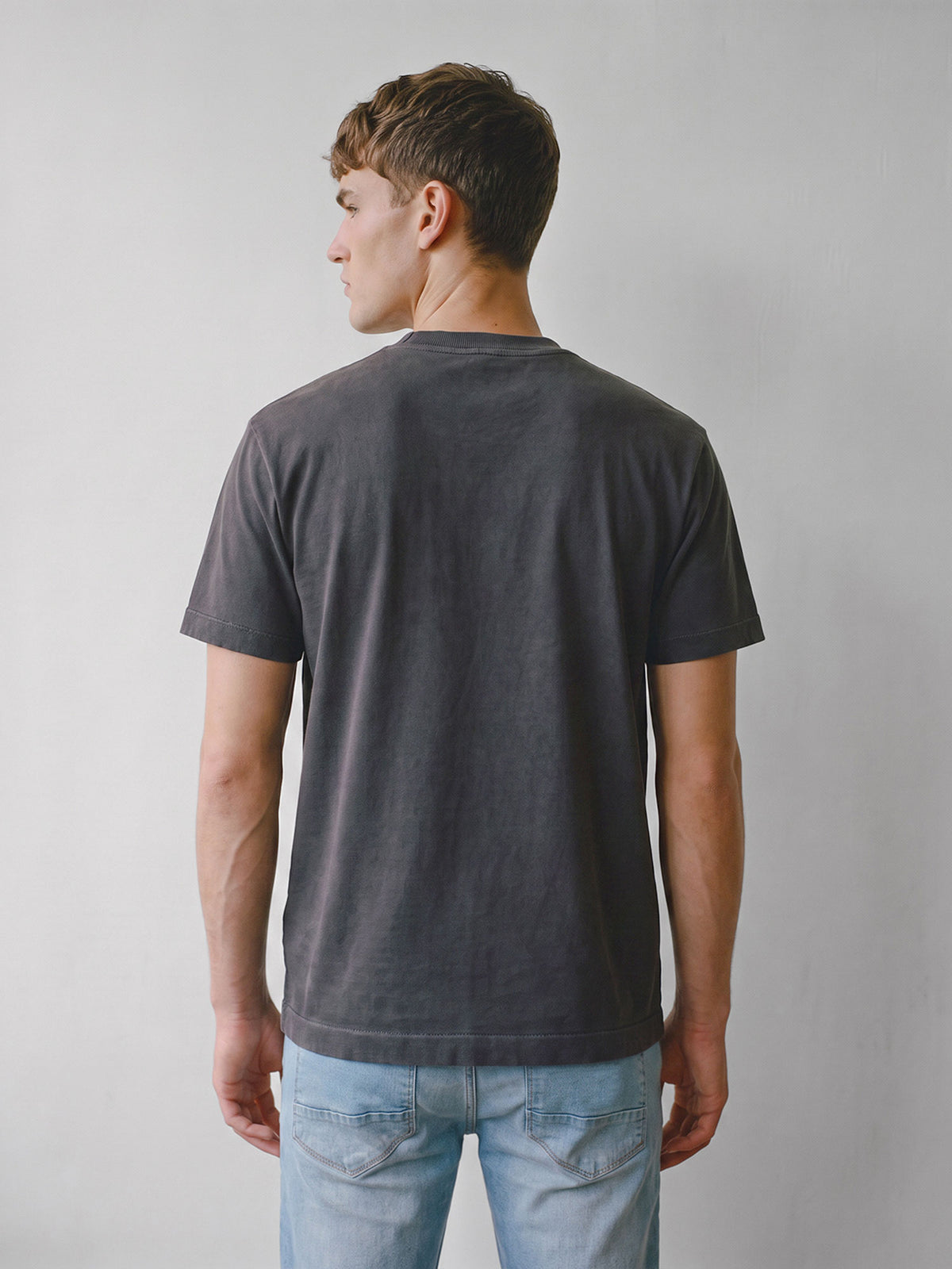 Back view of dark charcoal LUKE 1977 Nord relaxed fit dyed t-shirt worn by model