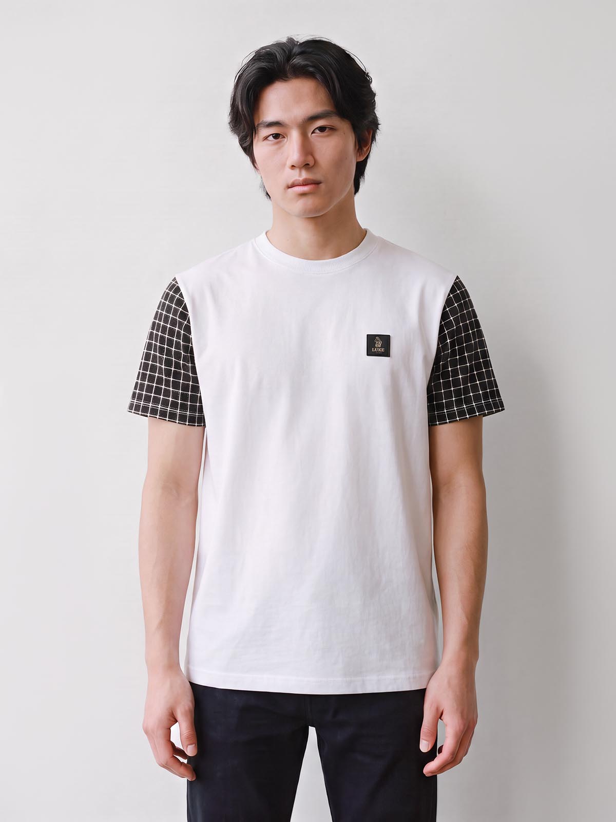 Man wearing white LUKE 1977 Dale check sleeve t-shirt, front view